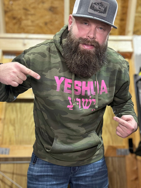 “YESHUA” in pink on camo hoodie